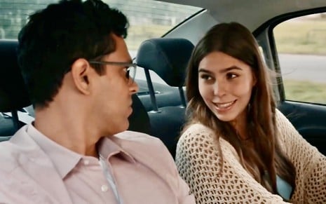 Renan Monteiro grava cena de Renascer em um carro com Gabriela Medeiros; eles estão caracterizados como Augusto e Buba